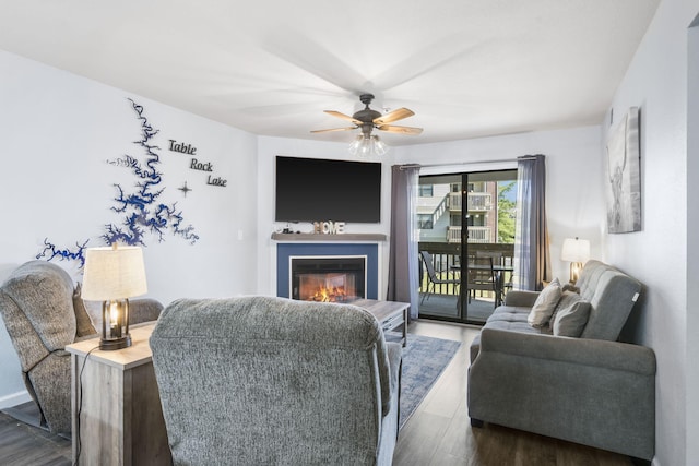 living room featuring dark hardwood / wood-style flooring and ceiling fan