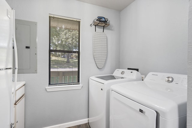 laundry room with electric panel and separate washer and dryer