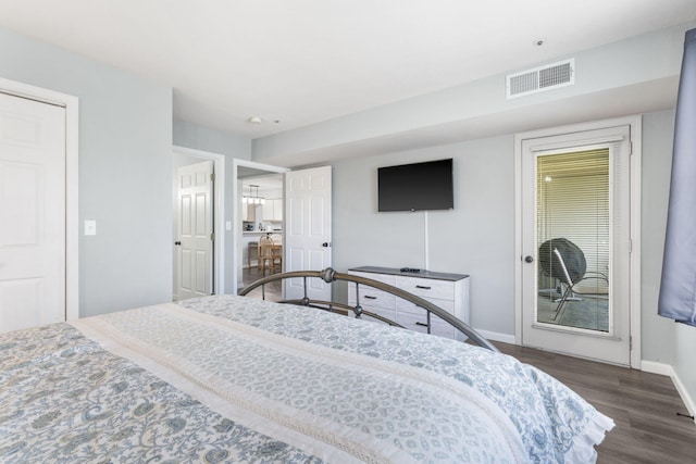 bedroom with dark hardwood / wood-style floors