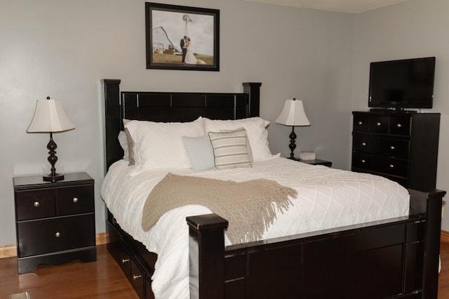 bedroom with dark wood-type flooring