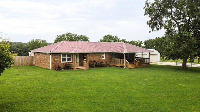 view of front facade featuring a deck, a garage, and a front lawn