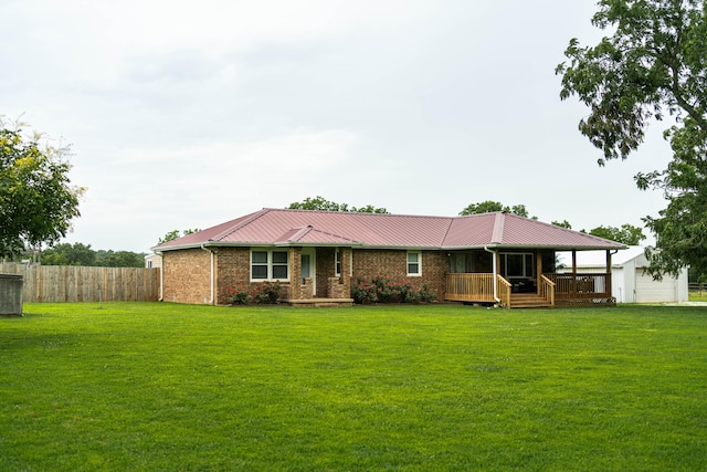 view of front of home featuring a garage, a front yard, and a deck