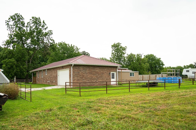 view of side of home with a lawn and a garage