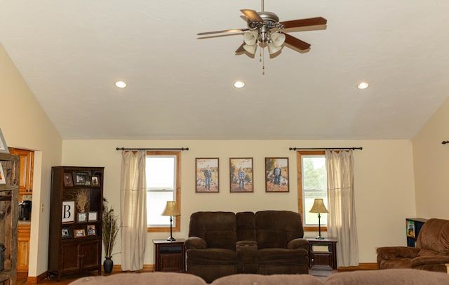 carpeted living room featuring vaulted ceiling and ceiling fan