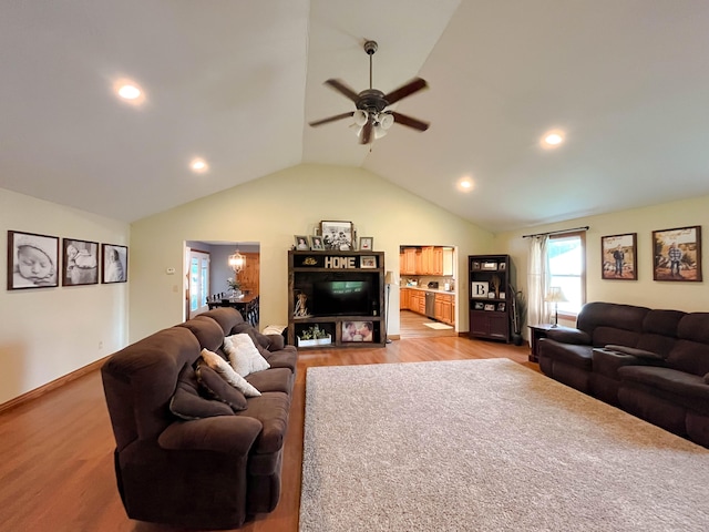 living room with lofted ceiling, light hardwood / wood-style flooring, and ceiling fan