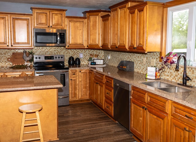 kitchen featuring decorative backsplash, sink, stainless steel appliances, and dark hardwood / wood-style flooring