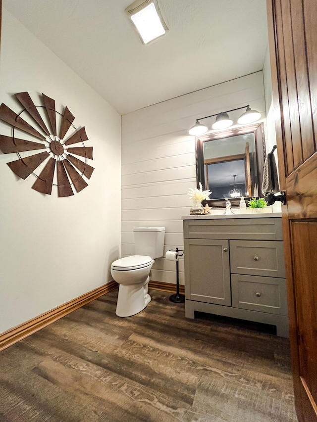 bathroom featuring vanity, toilet, and hardwood / wood-style flooring