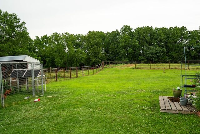 view of yard featuring an outbuilding and a rural view