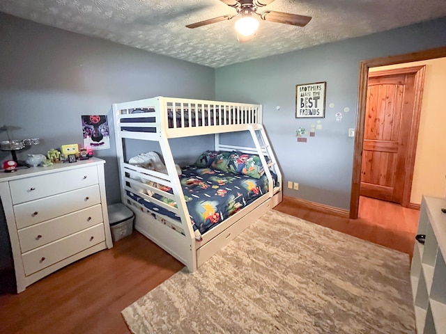 bedroom featuring ceiling fan, a textured ceiling, and light hardwood / wood-style flooring