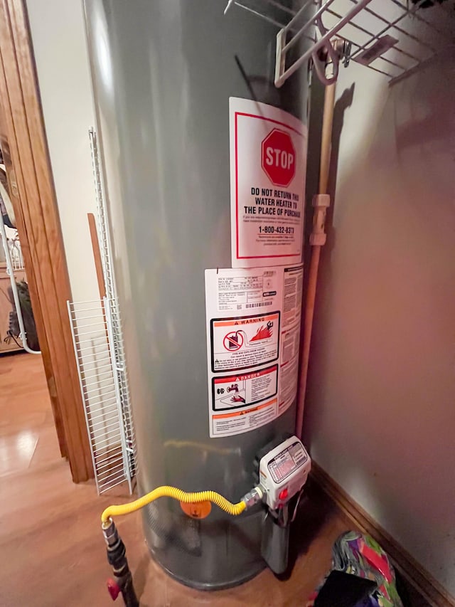 utility room featuring gas water heater