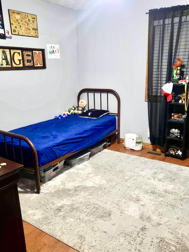 bedroom with wood-type flooring