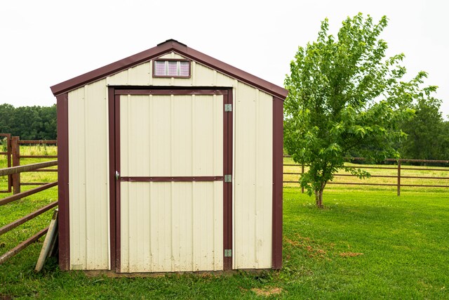 view of outbuilding featuring a lawn