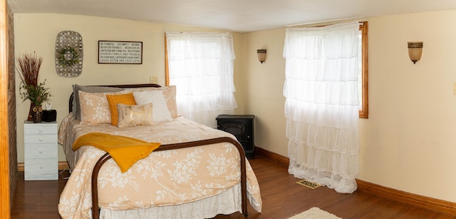 bedroom with dark hardwood / wood-style floors