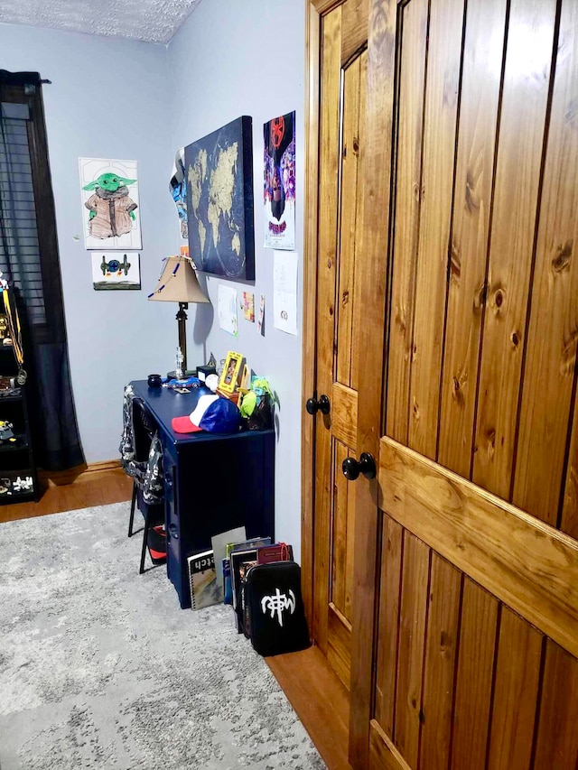 office space with light wood-type flooring and a textured ceiling