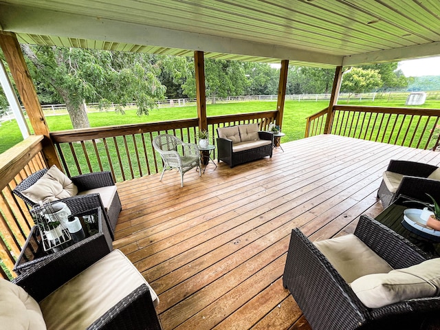 deck featuring outdoor lounge area and a lawn