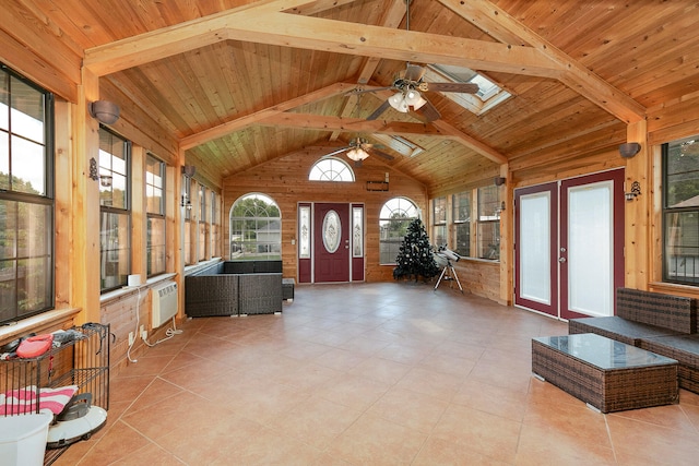 unfurnished sunroom with vaulted ceiling with skylight, a wall unit AC, ceiling fan, wooden ceiling, and french doors