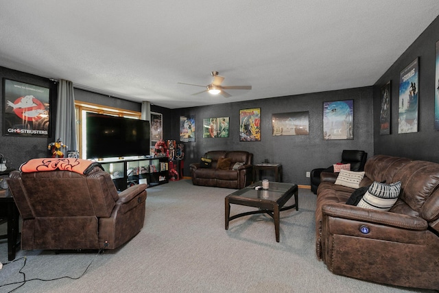 living room featuring ceiling fan, carpet, and a textured ceiling