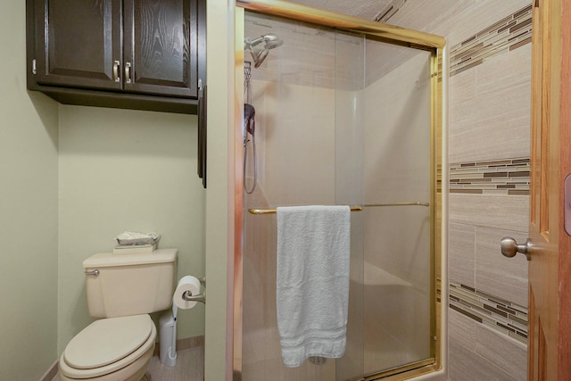 bathroom with a shower with door and toilet