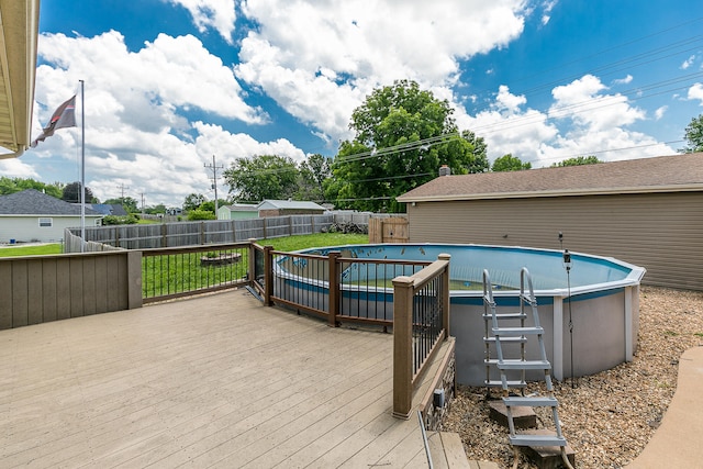 deck featuring a fenced in pool