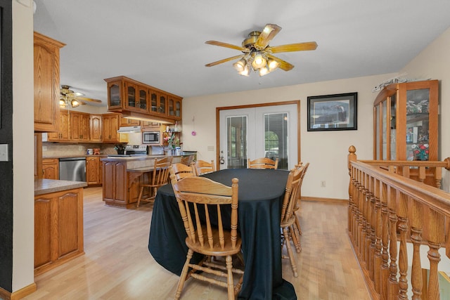 dining area with french doors, light hardwood / wood-style floors, and ceiling fan