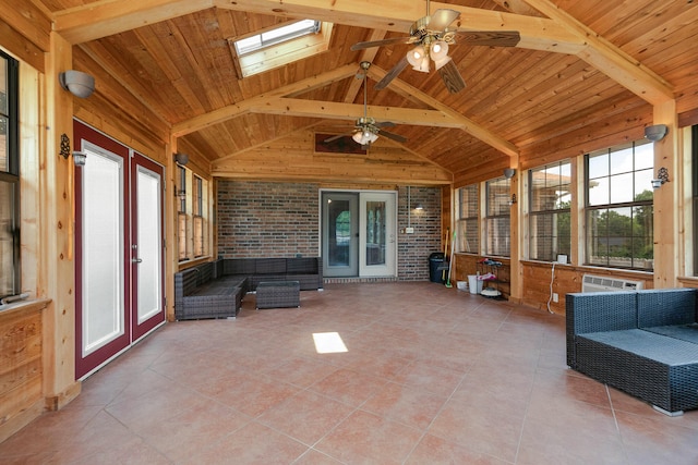 unfurnished sunroom featuring ceiling fan, plenty of natural light, and wooden ceiling