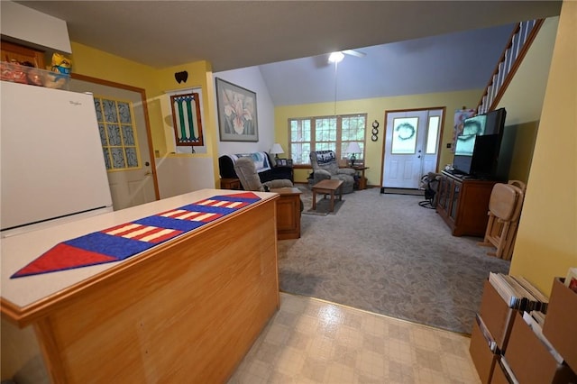 living room with lofted ceiling and light carpet