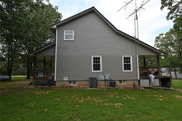 view of side of home with a wooden deck, a lawn, and central air condition unit