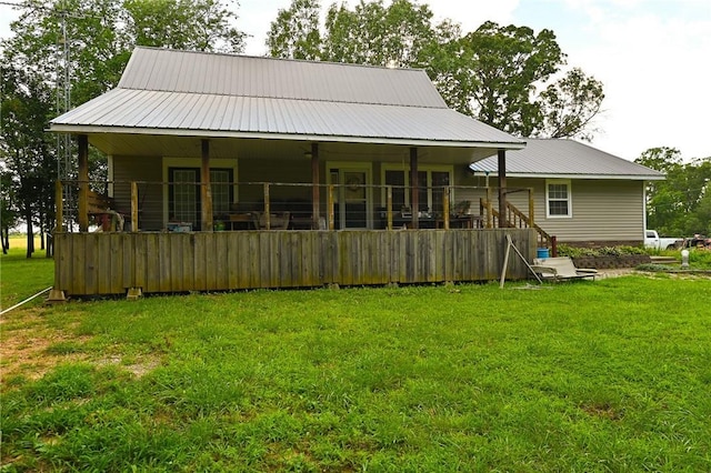 rear view of house with a yard