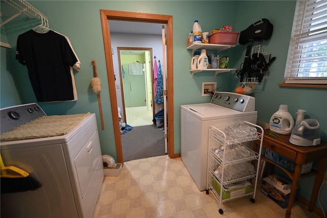 clothes washing area featuring washing machine and dryer and light colored carpet