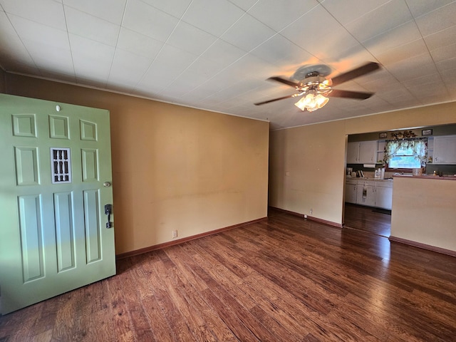 unfurnished living room with dark wood-type flooring and ceiling fan