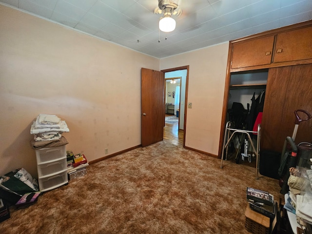 unfurnished bedroom featuring ceiling fan, a closet, and carpet