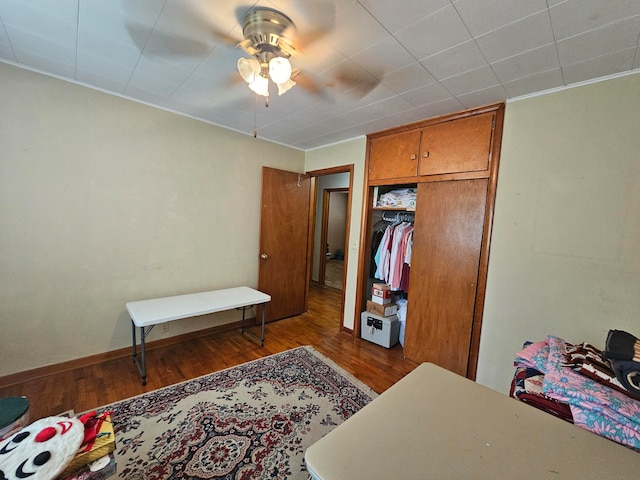 bedroom with ceiling fan, a closet, and hardwood / wood-style floors