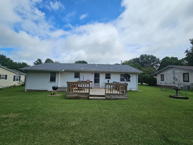 back of property with a yard and a wooden deck