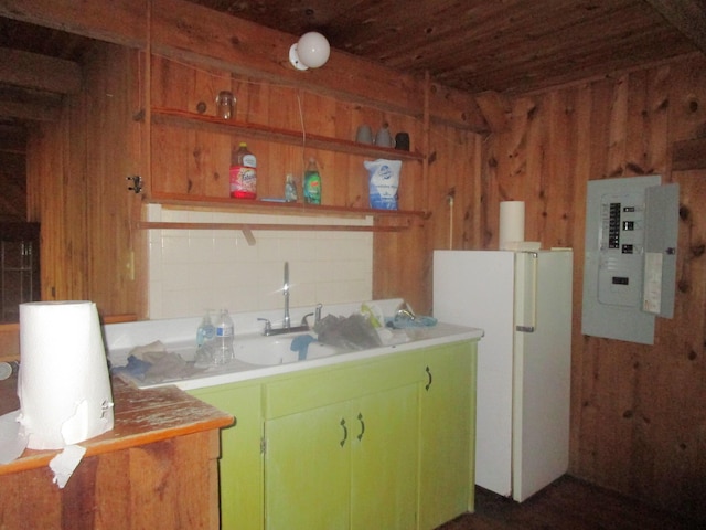 kitchen with electric panel, freestanding refrigerator, wood walls, open shelves, and light countertops