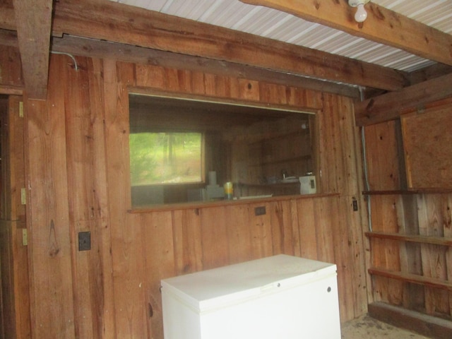 clothes washing area with wooden walls