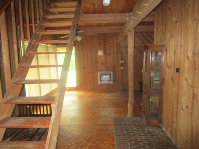 stairs featuring ceiling fan