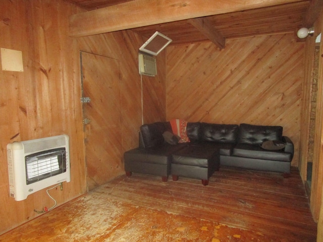 living area featuring hardwood / wood-style flooring, wood walls, heating unit, and beamed ceiling