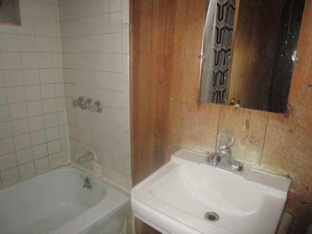 bathroom with decorative backsplash and sink