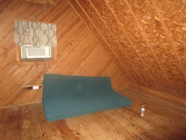 interior details with wooden walls, wood finished floors, and cooling unit