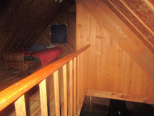 interior space featuring lofted ceiling, wood walls, and a sauna