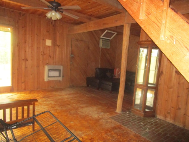 interior space with a wall mounted AC, wood walls, a ceiling fan, and heating unit