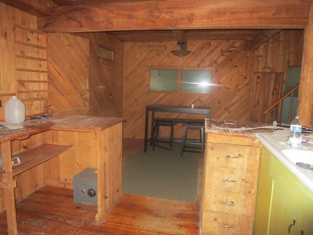 kitchen with wooden walls and wood-type flooring