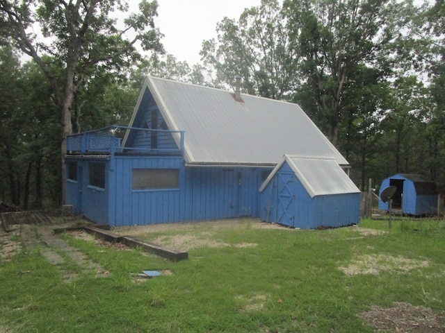 exterior space featuring a yard and a storage unit