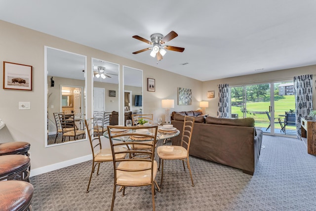 carpeted dining area with baseboards and ceiling fan
