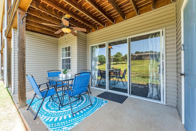 view of patio with outdoor dining area and ceiling fan