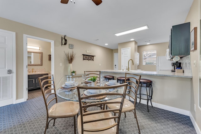 dining space with baseboards, a ceiling fan, visible vents, and dark carpet