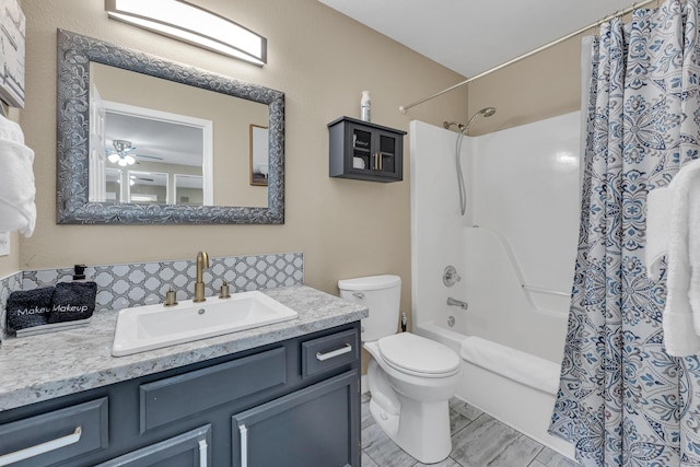full bath featuring shower / bath combination with curtain, vanity, and toilet
