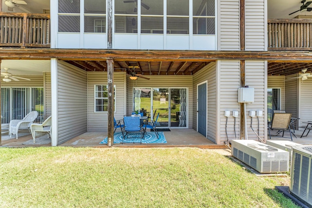 rear view of house with a patio area, a yard, a ceiling fan, and cooling unit