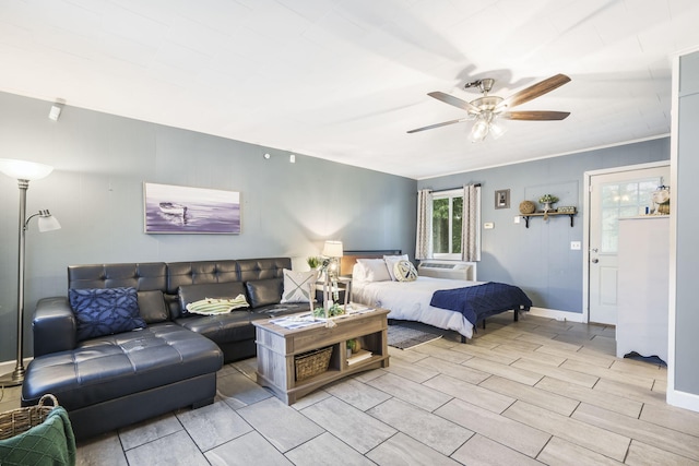 bedroom featuring ceiling fan, light wood-type flooring, and ornamental molding