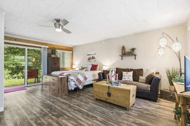 bedroom with ceiling fan, dark hardwood / wood-style flooring, and access to outside